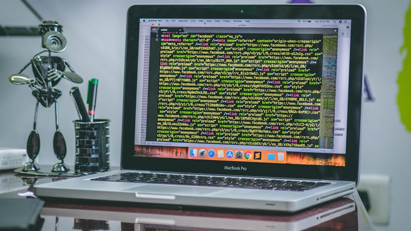 Laptop displaying code on screen.